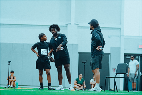 Coach instructing an athlete on combine day